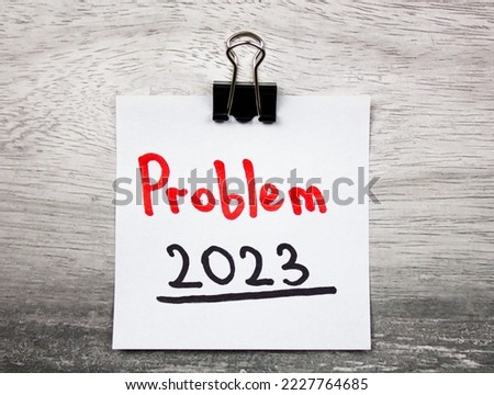 Problem 2023 text concept on note sheet, on table.