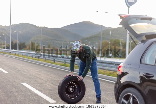 Problem with car, flat tire,\
highway