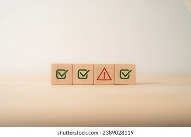 Problem and error warning concept. Wooden cubes with triangle caution warning sign, warning system for notification error and maintenance. Incident, risk, contingency management. Proactive approach.