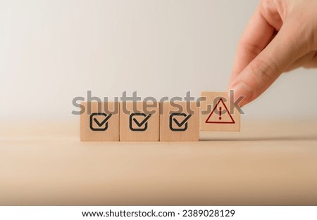 Problem and error warning concept. Wooden cubes with triangle caution warning sign, warning system for notification error and maintenance. Incident, risk, contingency management. Proactive approach.