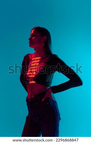Problem. One attractive woman wearing trendy clothes with neon filter lights with inscryption on body on bright green mode background. Concept of digital art, online, fashion, cyberpunk, futurism