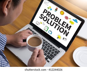 PROBLEM SOLUTION Businessman at work. Close-up top view of man working on laptop while sitting at the wooden desk , coffee