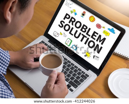 PROBLEM SOLUTION Businessman at work. Close-up top view of man working on laptop while sitting at the wooden desk , coffee