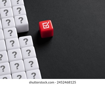 Problem solving, analysis and correction in business. Making the right choice. Decision making under ambiguity. Checkmark symbol stands out from the question mark symbols.