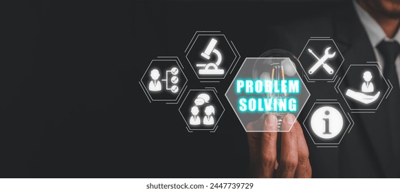Problem solving concept, Businessman hand holding light bulb with problem solving icon on virtual screen.