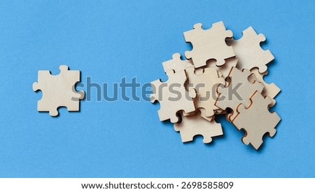 Problem Solving Concept: Single Unused Jigsaw Piece Beside a Pile of Parts