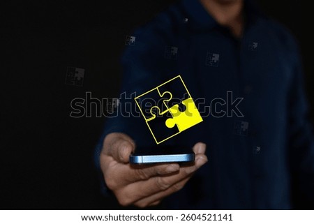 Problem Solving Strategy Concept and Problem Solving Concept The businessman shows a jigsaw puzzle icon on a virtual screen. The jigsaw pieces fit together to show the solution.