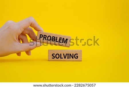 Problem solving symbol. Concept word Problem solving on wooden blocks. Businessman hand. Beautiful yellow background. Business and concept. Copy space