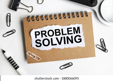 PROBLEM SOLVING, text on white paper on a white background near a magnifying glass and pencils - Shutterstock ID 1880066095