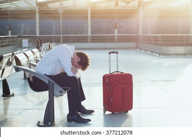 problem with transportation, delay of flight, depressed commuter with his luggage