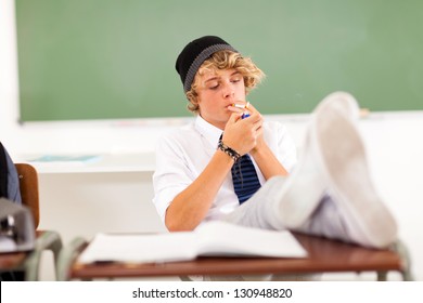 Problematic Teen Boy Smoking In Classroom