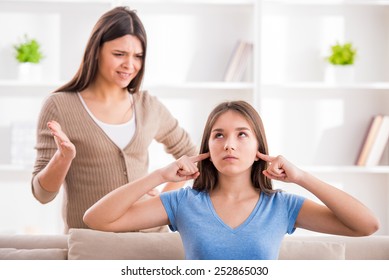 Problems Between Generations Concept. Teen Closed His Ears With His Hands While Her Mom Yells At Her.