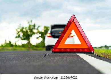 Problems Car And A Red Triangle Warning Sign On The Road