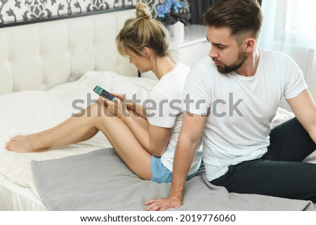 Problems in a couple 's relationship. Cheating and mistrust concept. Jealous man looking in his girlfriend's phone.