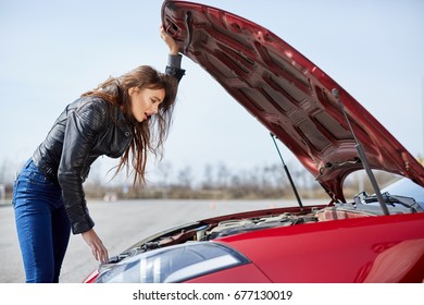 Problems With Engine, Confused Driver.  Profile Of Stressed  Woman Standing Near Car, Broken Down. Looking Inside Of The Red Car, Outside