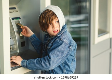 Problems Pre Teen Boy In Hood, Take Money In Cash Dispenser For Alien Card. Boy Takes Cash At ATM Machine. Kids Theft. Stealing Credit Card From Parents.