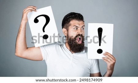Problems. Question mark. Pensive man and a thoughtful. Man a question, exclamation point. Concept of question, exclamation marks. Man with a question and exclamation mark. Man makes a choice.