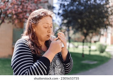 Problems with smoking. Overweight depressed woman smokes outside to calm down. Hormonal failure. Problems with obesity. Lonely people. Mental health. Mental problems. Stress, panic, fear. - Powered by Shutterstock