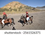 Probolinggo, Indonesia - Juny 17, 2018 : Riding a horse on the expanse of Mount Bromo