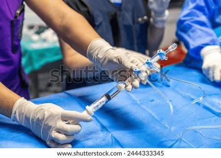 The procedure of inserting a double lumen catheter into a patient with cardiovascular occlusion in the hospital. Doctor insert double lumen catheter. insert guide wire. 