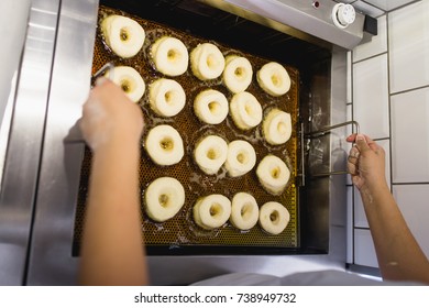 Procedure Of Making Donuts In A Small Town Donut Bakery - Donuts Frying In A Deep Fryer. Selective Focus. 