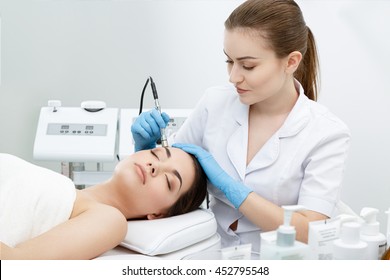 Procedure of Microdermabrasion. Mechanical Exfoliation, diamond polishing. Model and doctor. Cosmetological clinic. Healthcare, clinic, cosmetology