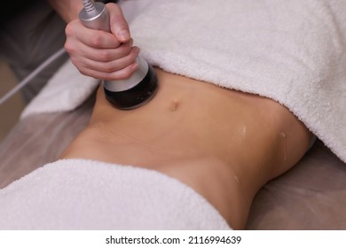 procedure removing cellulite on female abdomen, cavitation belly massage. Ultrasonic massage for weight loss. Correction of female figure without surgical intervention. Closeup of the tummy.