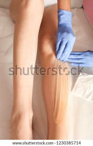 Procedure for removing hair with sugar paste on legs. Concept shugaring.