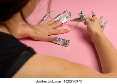 The Procedure For Removing Varnish From Nails Hybrid Nails In Progress. Gel Nail Polish Remover Foils On Woman's Hands