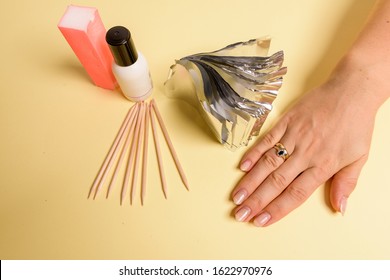 The Procedure For Removing Varnish From Nails Hybrid Nails In Progress. Gel Nail Polish Remover Foils On Woman's Hands