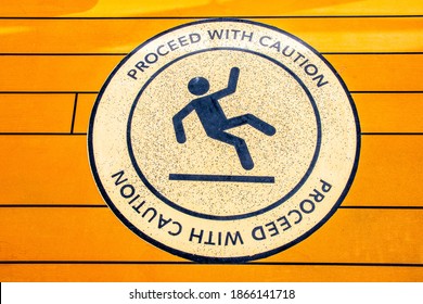 Proceed With Caution sign to alert of slippery floor showing symbol of person falling to the ground. - Shutterstock ID 1866141718