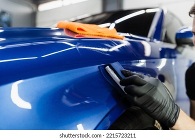 Process of applying ceramic protective coat on body car using sponge in detailing auto service. Car service worker apply ceramic coating to protect the car body from scratches - Shutterstock ID 2215723211