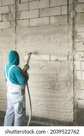 The Process Of Applying Plaster To Walls Inside A Building By Machine.