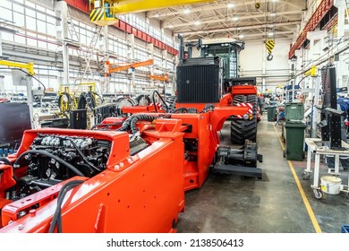Process of assembling industrial agricultural machine in factory. Harvester or tractor production line