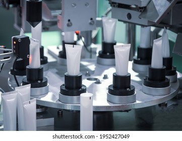 Process of automatic cosmetic tubes filling and sealing machine. Pharmaceutical industry