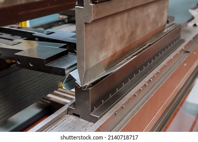 The process of bending galvanized sheet metal 2 millimeters thick on a special machine for bending metal plates.