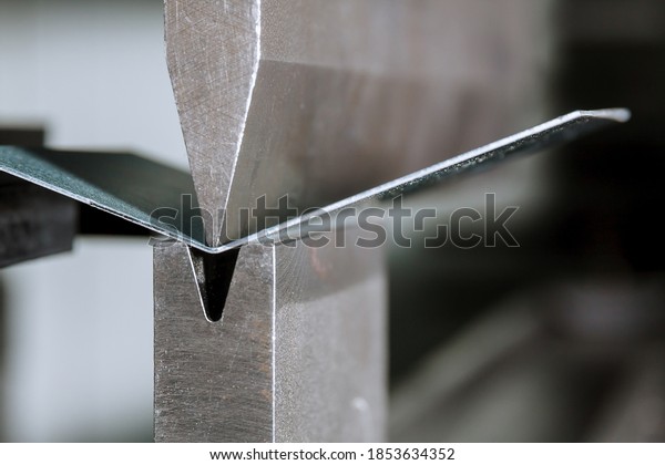 The process of bending sheet metal on a hydraulic\
bending machine