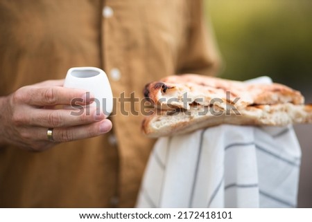 The process of breaking bread. Religious tradition of breaking bread. Bread and wine. Preparation for the church ceremony.