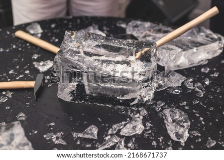 Process of breaking the ice with hammer and ice pick, group of people smashing shattered ice cube, team work success concept, concept of starting event, conversation
