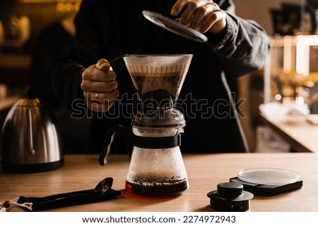 Process of brewing clever coffee dripper with pour over filter in cafe. Alternative method of brewing coffee in clever dripper at home