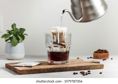 The Process Of Brewing Coffee. Water Is Poured Into A Drip Coffee Bag In A Mug. Trends In Brewing Coffee At Home.