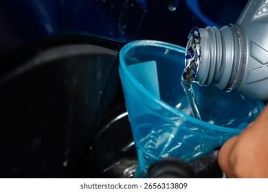 The process of changing engine oil by adding and pouring new, clear, quality engine oil into the motorcycle engine. Engine maintenance system and fuel energy concept.