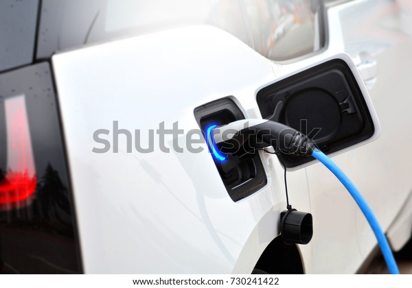 The process of charging an electric vehicle.\
Electric car socket.
