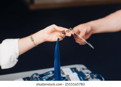 Process of checking in on conference congress forum event, registration desk table, visitors and attendees receiving lanyard with name badge and entry wristband bracelet and register electronic ticket - Powered by Shutterstock