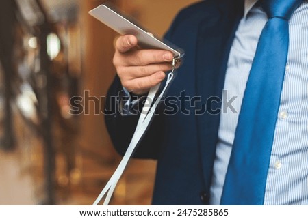 Process of checking in on a conference congress forum event, registration desk table, visitors and attendees receiving a name badge and entrance wristband bracelet and register electronic ticket