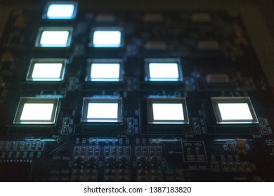 The process of checking several oled displays on the test station. Displays glow brightly.
