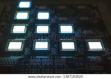The process of checking several oled displays on the test station. Displays glow brightly.