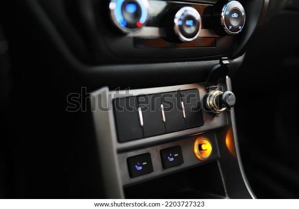 The\
process of choosing climate control in the car. Man regulating\
temperature on car air condition. Modern car\
interior
