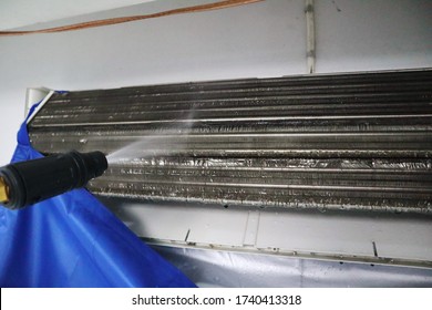 the process of clean and wash the air condition with the high pressure electric pump in the bedroom during hot summer evaporator coil