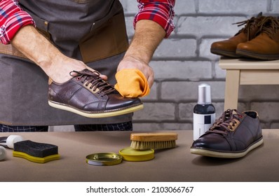 The Process Of Cleaning Shoes. Man Shining Shoes At Home.